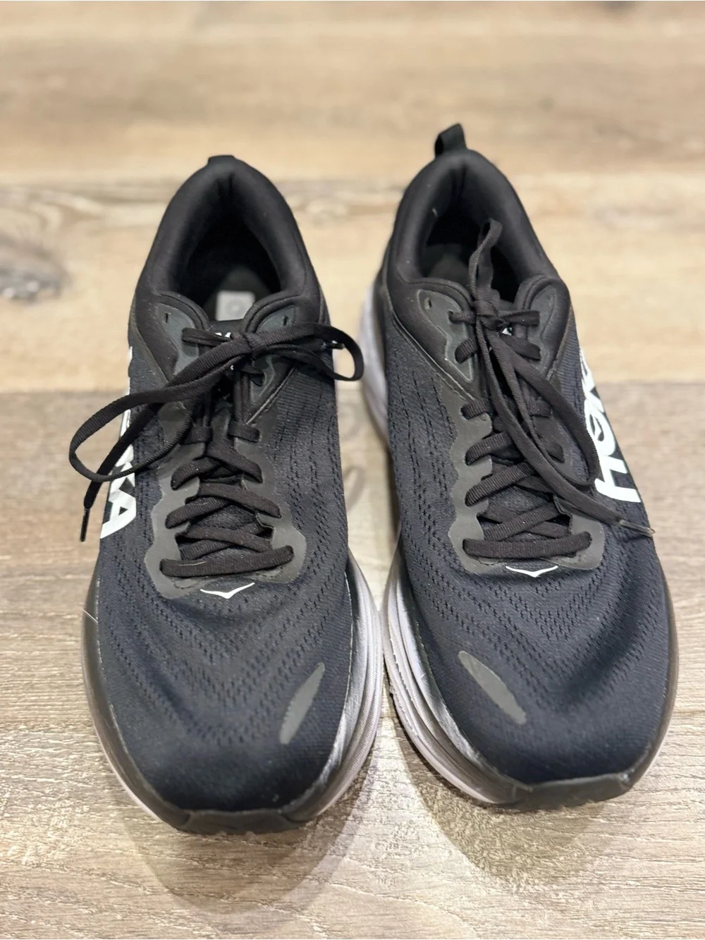 Hoka One One Bondi 8 running shoes feature a black upper and a white midsole